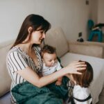 mother with two children at home in a cozy setting