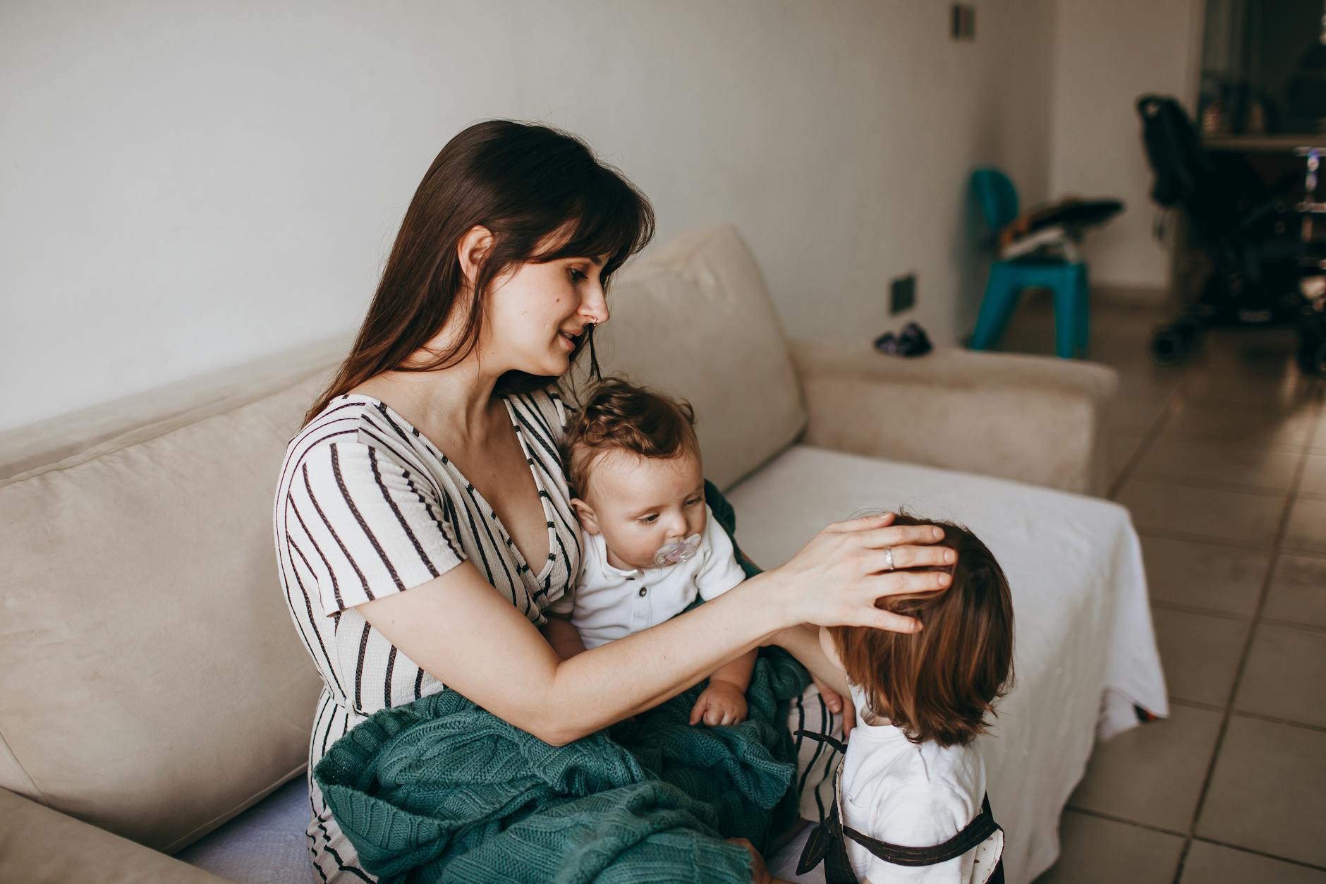 mother with two children at home in a cozy setting