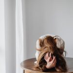 sad woman lying down on table
