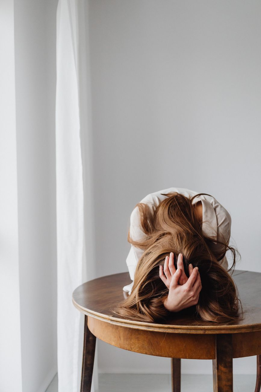 sad woman lying down on table